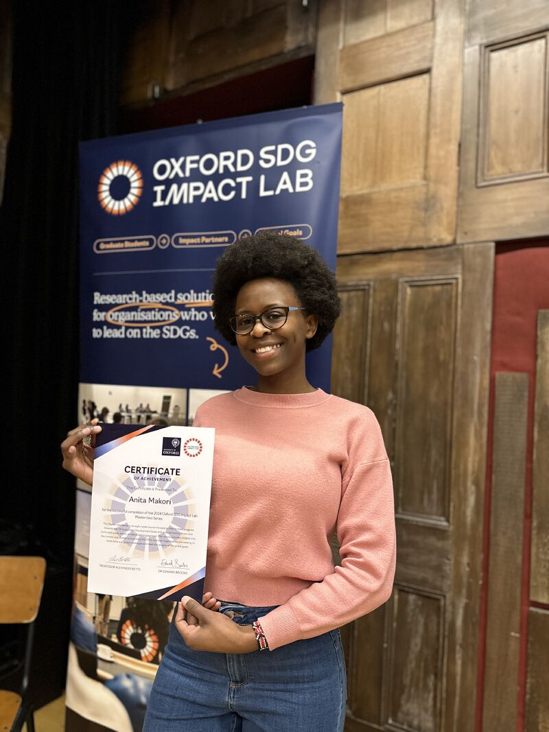 Anita Makori holding her Lab Masterclass Certificate