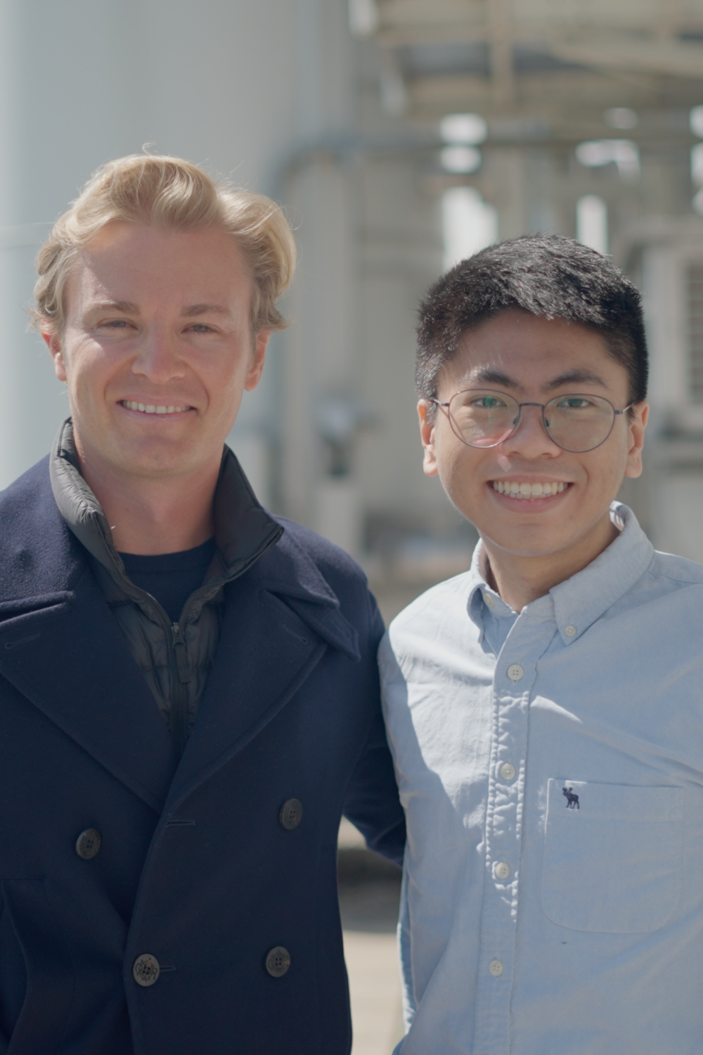 Nico Rosberg and john Chua smiling to camera