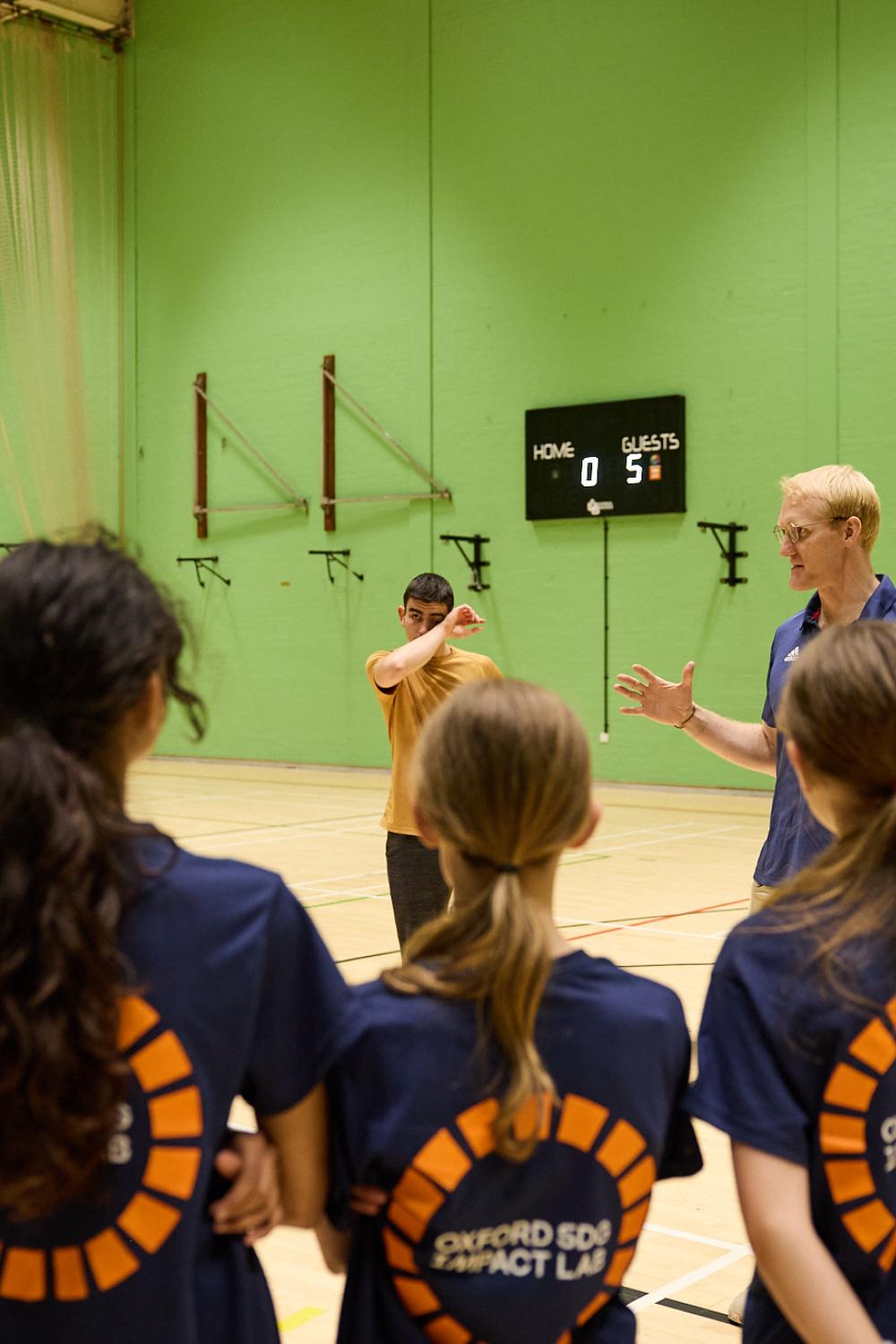 Programme Manager Oliver Cook addressing the pupils in a sports hall